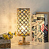Vintage gold and crystal lamp lit up on a table with books. 