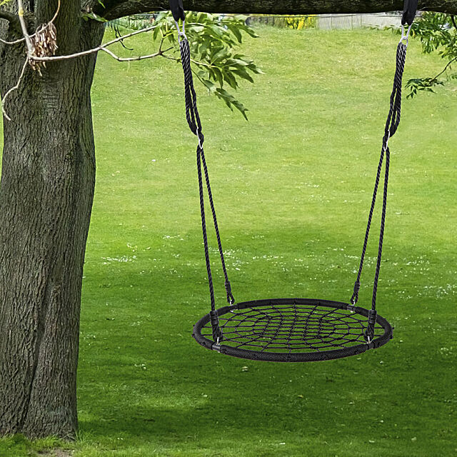 40 Inch spider web swing, for kids & adults hanging from a tree with grassy background.