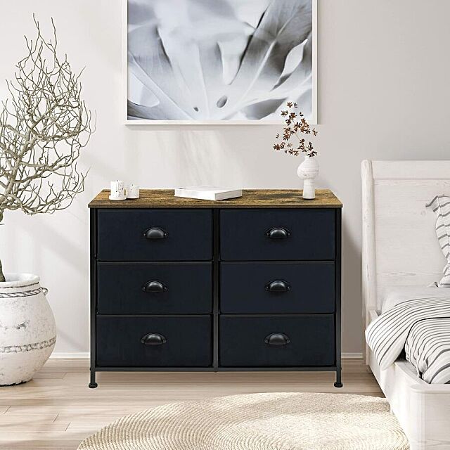 Tall dresser with fabric storage drawers in a bedroom.
