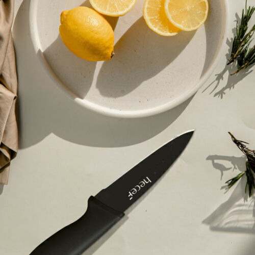 Kitchen knife next to a plate of lemons. 