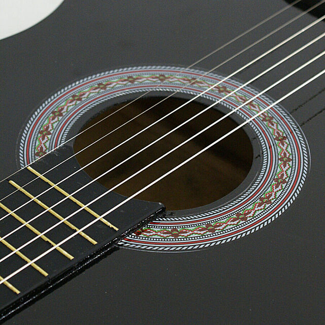 Close up of the center of the acoustic guitar. 