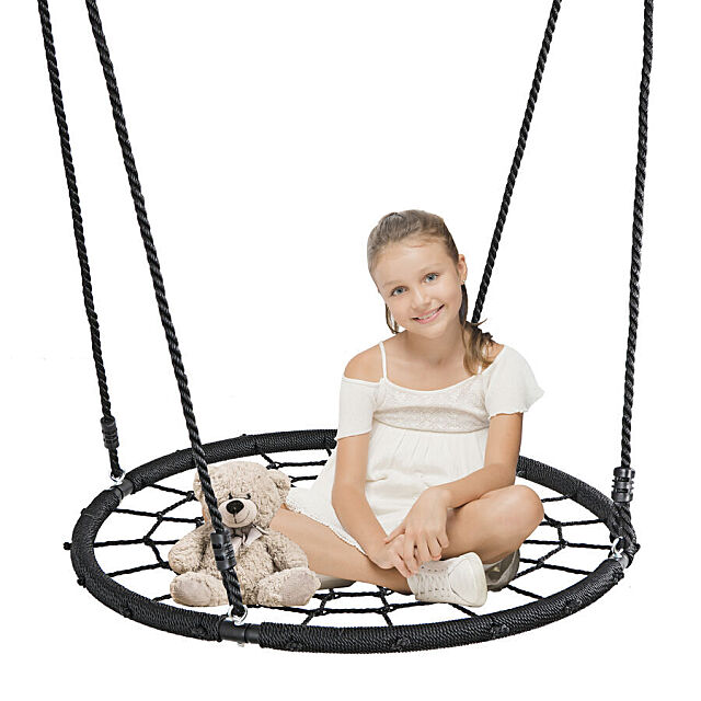 Spiderweb swing with a young girl sitting on it.